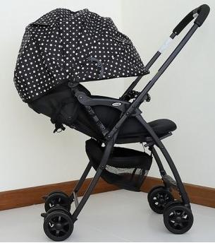 A stroller with a large hood is the choice of a demanding mother
